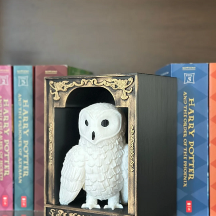 White owl figurine in a decorative box with 'Harry Potter' books in the background